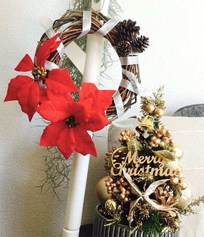 Christmas wreath on display with a christmas tree