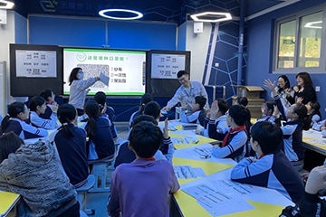 Students actively raising their hands during the lesson
